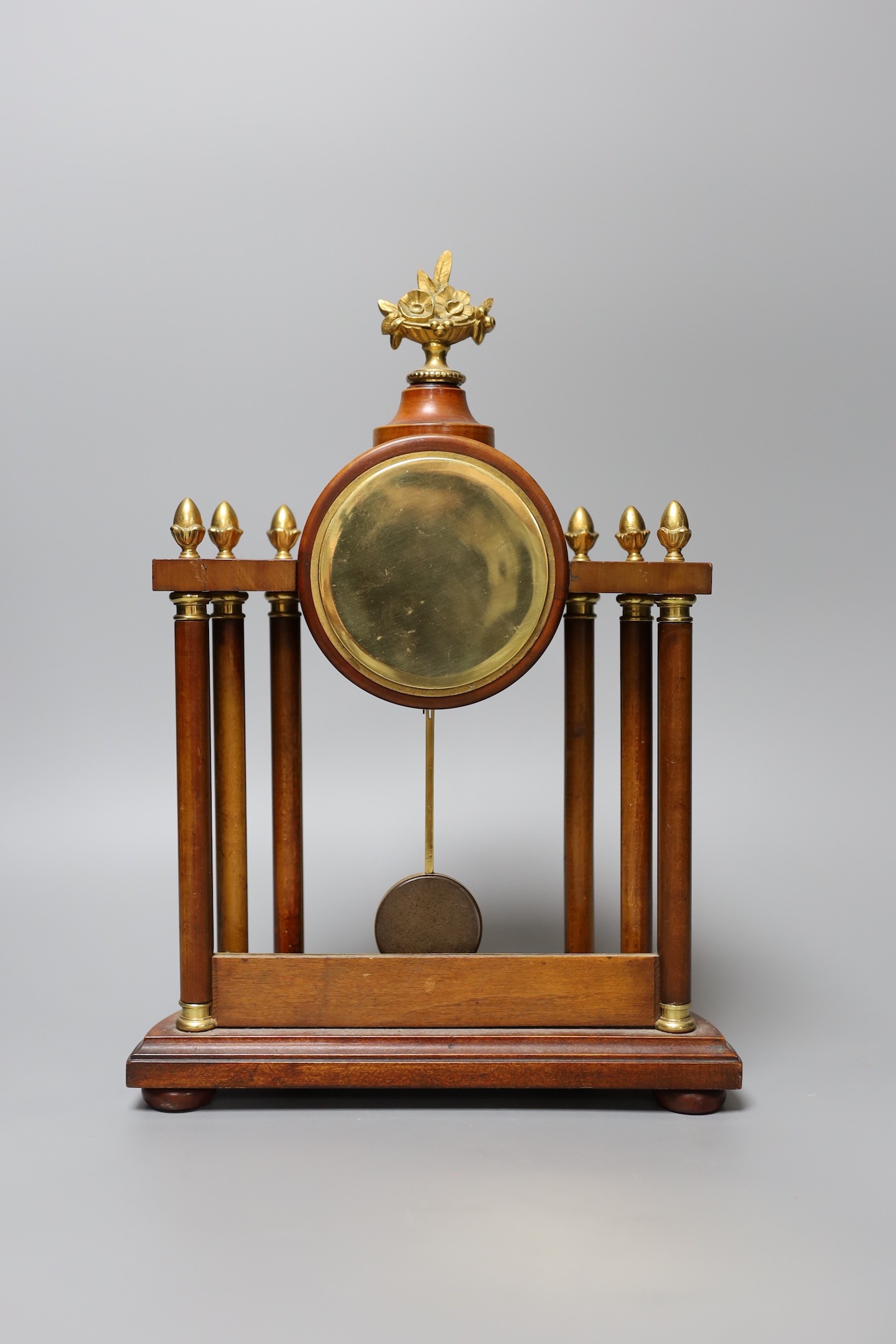 A small French portico clock with column decoration, 29cm tall